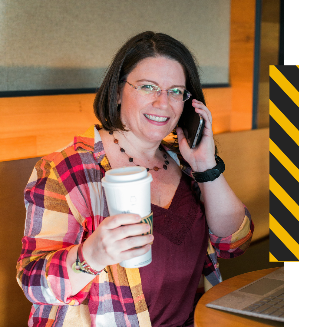 Safety Brye on the phone holding a coffee