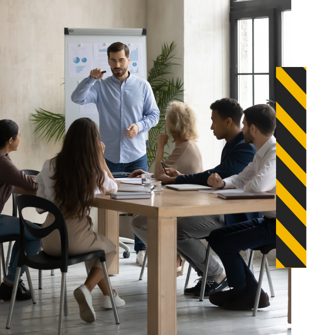 a person in front of a flip chart leading a training